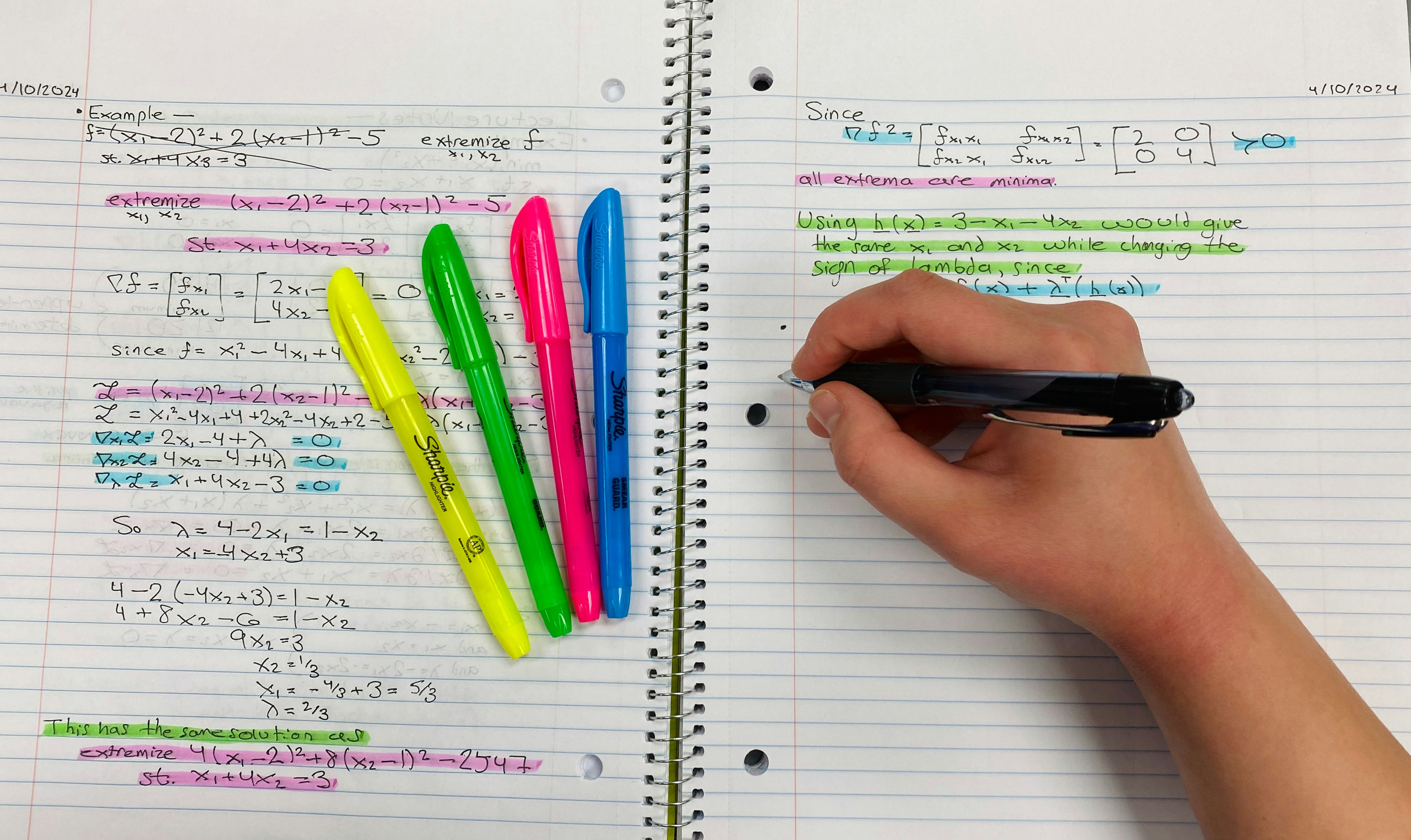 Student writing focused in a notebook